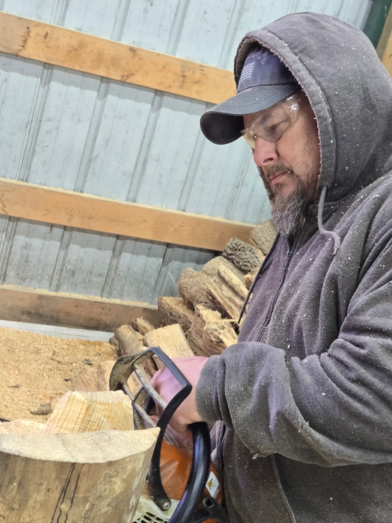 Close-up of Gene using a chainsaw to detail a carving